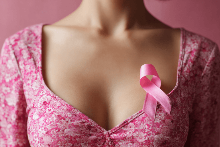 Woman wearing pink ribbon symbol for breast cancer awareness and early detection