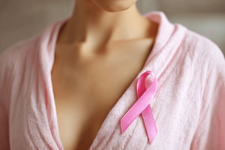 Atypical ductal hyperplasia surgery awareness concept with pink ribbon on woman’s chest