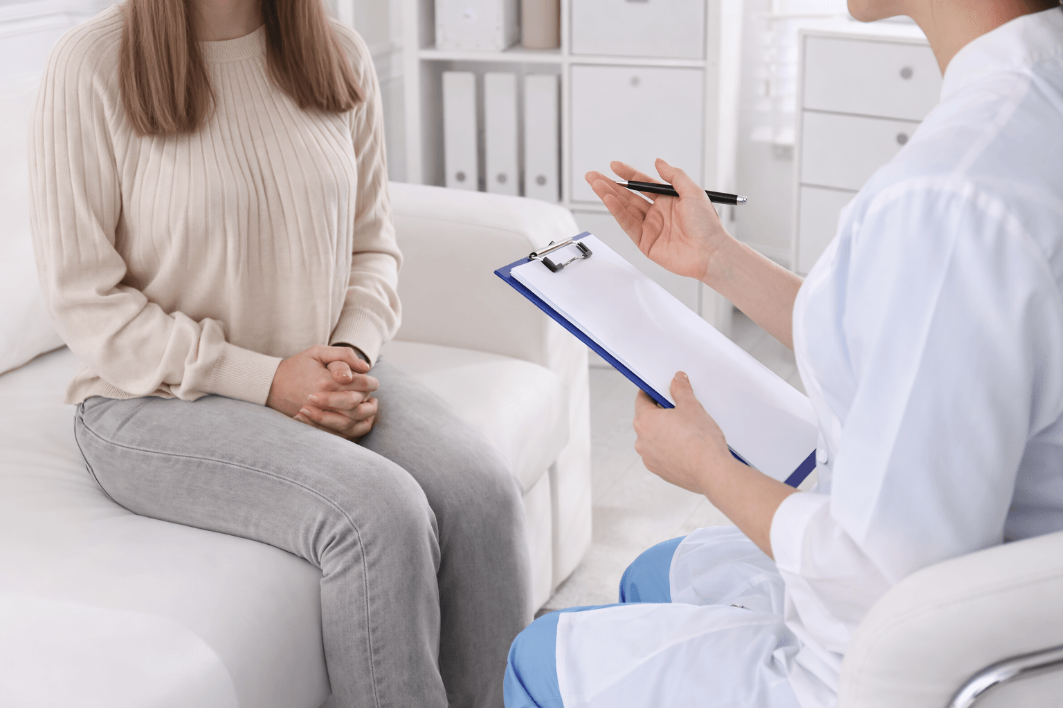 Why Women Often Carry Herpes Without Symptoms 1 Female patient discussing herpes test results with a doctor during a medical consultation in a clinic setting
