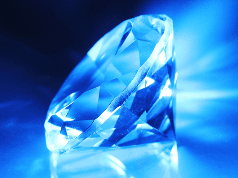 Close-up of a radiant blue diamond representing Heerak Bhasma (Diamond Bhasma, Diamond Ash) with text "10 Healing Properties," highlighting its Ayurvedic healing benefits.
