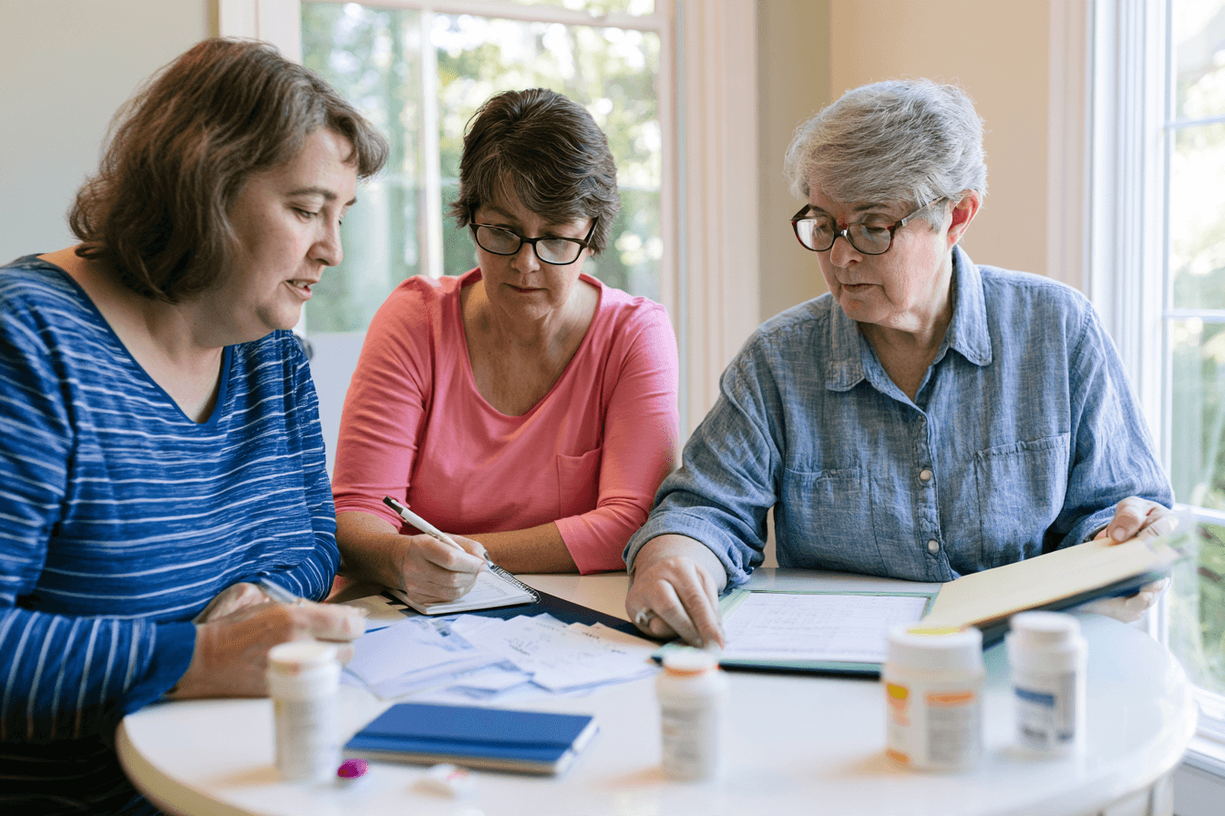 Patient and family member organizing medical reports and medicines before a consultation.