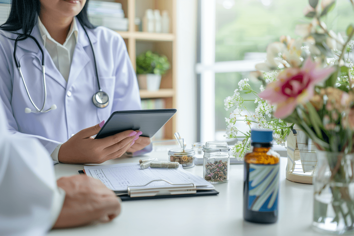 Ayurvedic doctor explaining pancreatic cancer with herbs and modern tools