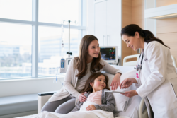 Illustrative bone marrow transplant for thalassemia consultation with a child, parent and hematologist in a modern hospital.