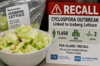 Home 8 Cyclospora lettuce outbreak 2026 recall warning beside packaged iceberg lettuce and a fresh salad