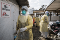 Home 6 Drc ebola outbreak illustration showing healthcare workers in protective gear caring for a patient in a treatment unit.