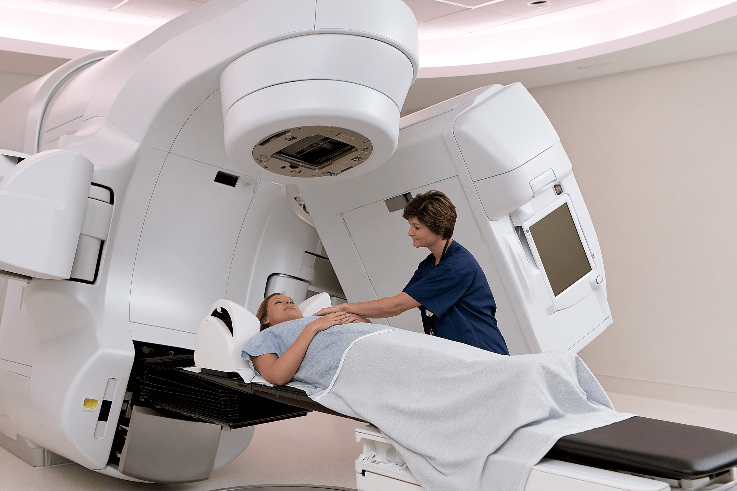 Metastatic Esophageal Cancer Treatment: Biomarker-Guided Care 6 Radiation therapist positioning a patient on a treatment couch beneath a linear accelerator.