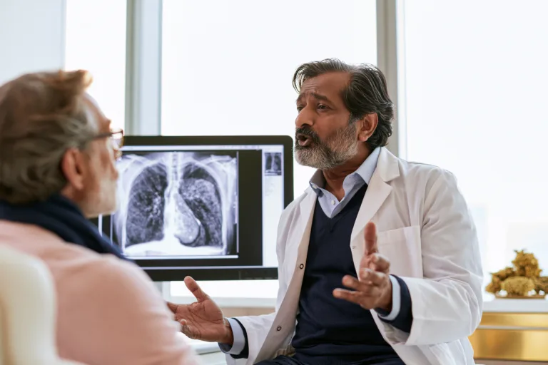 Home 4 Pleural mesothelioma treatment consultation with a doctor reviewing a chest ct scan with a patient