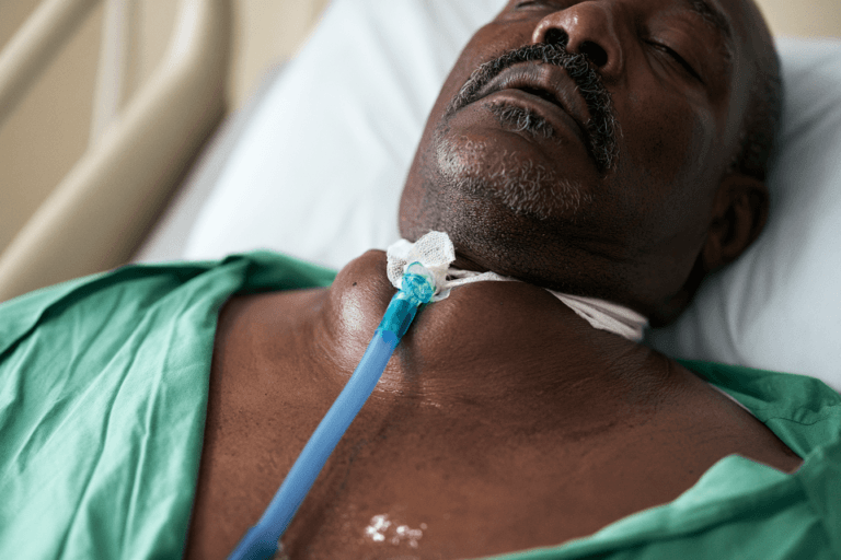 Patient with advanced anaplastic thyroid cancer, severe neck swelling and a tracheostomy before radiation and chemotherapy for ATC.