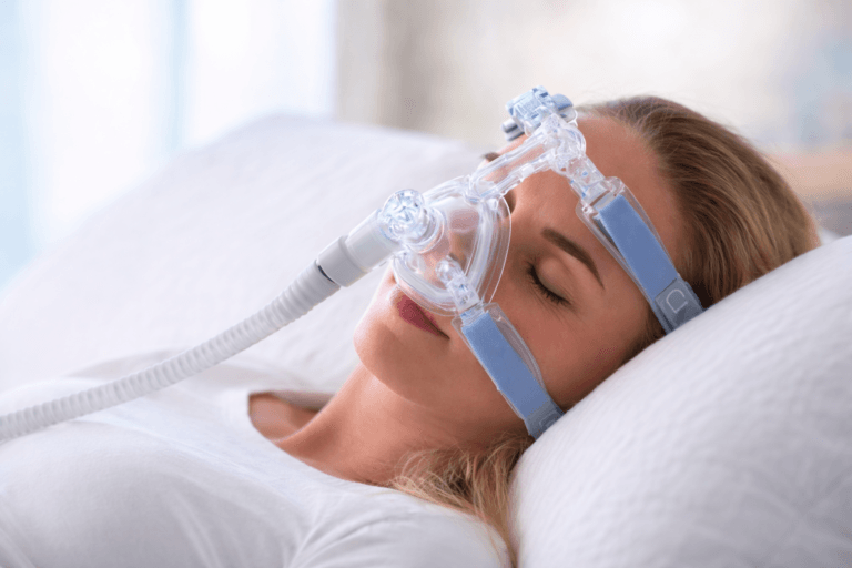 Woman sleeping with CPAP mask used for sleep apnea treatment