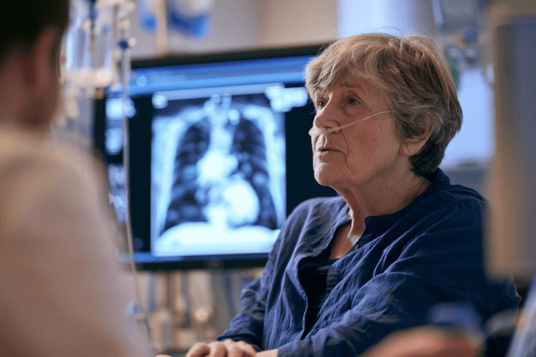 Home 1 Small cell lung cancer patient discussing chest ct findings and treatment with an oncologist in a modern hospital.